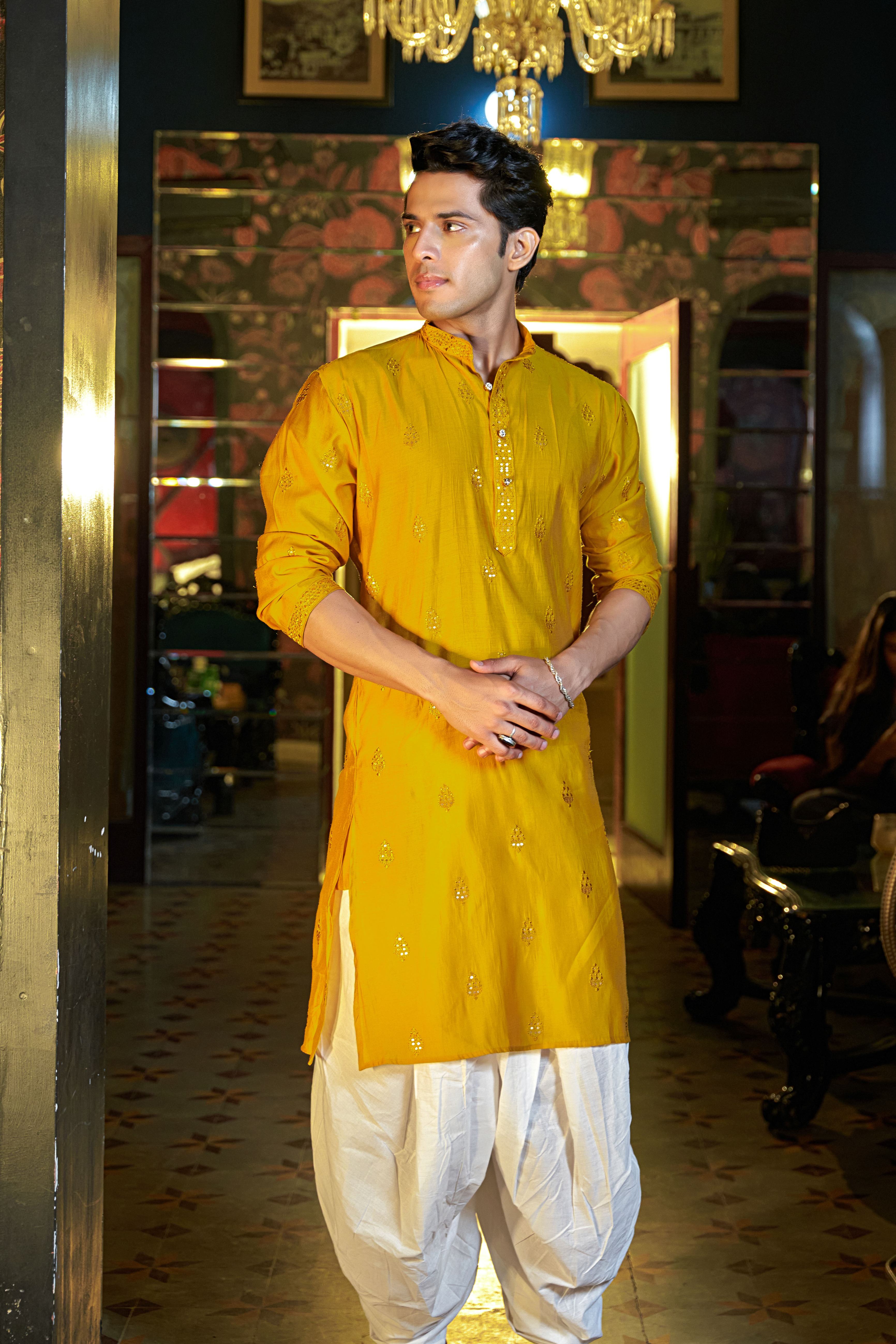 bright yellow embroidery work kurta worn by and Indian man