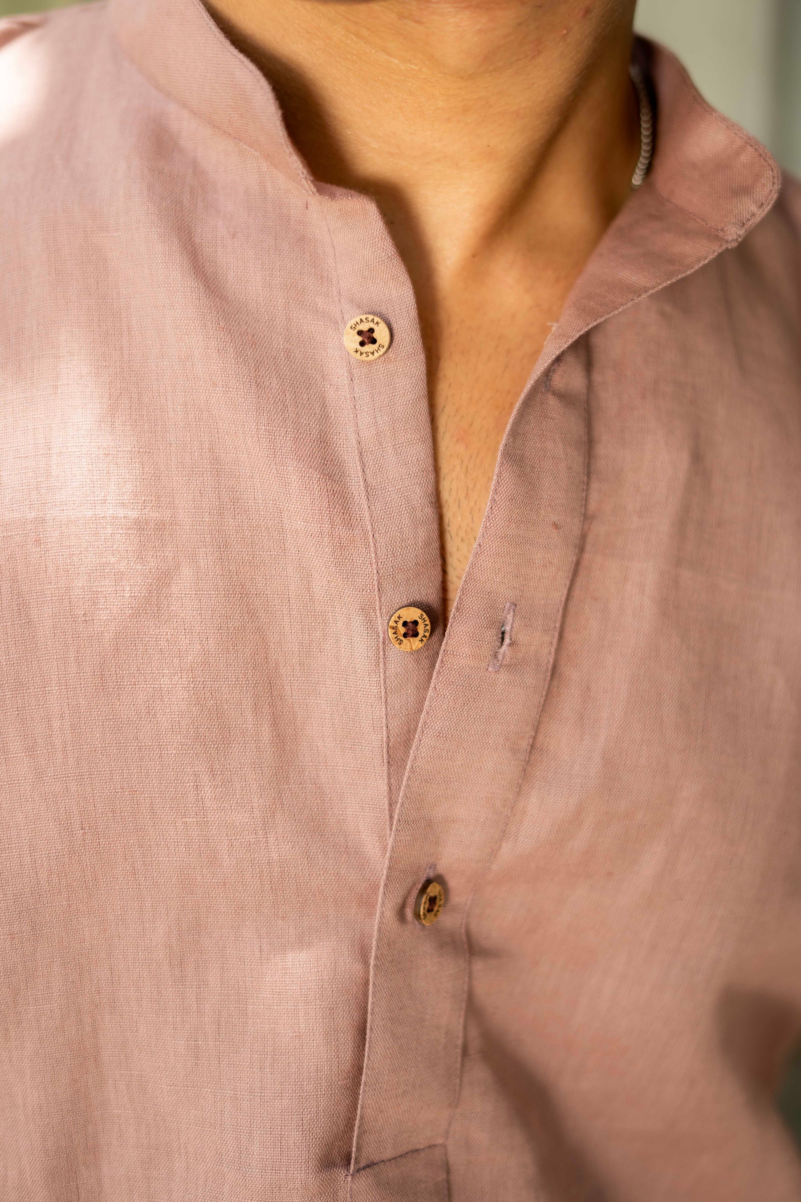 close-up view of light purple kurta. featuring wooden buttons