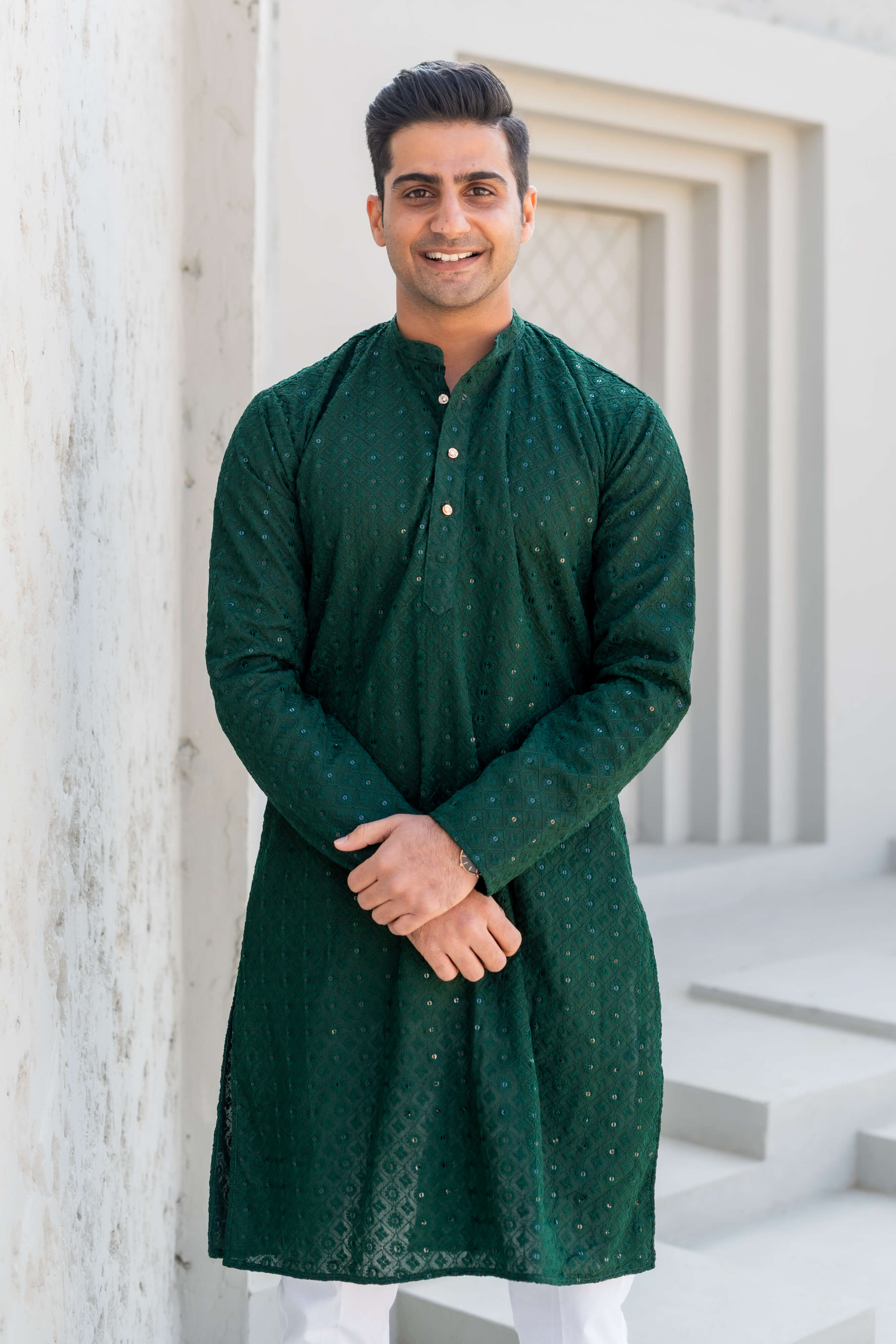 Indian man in dark green chikan kari long kurtas